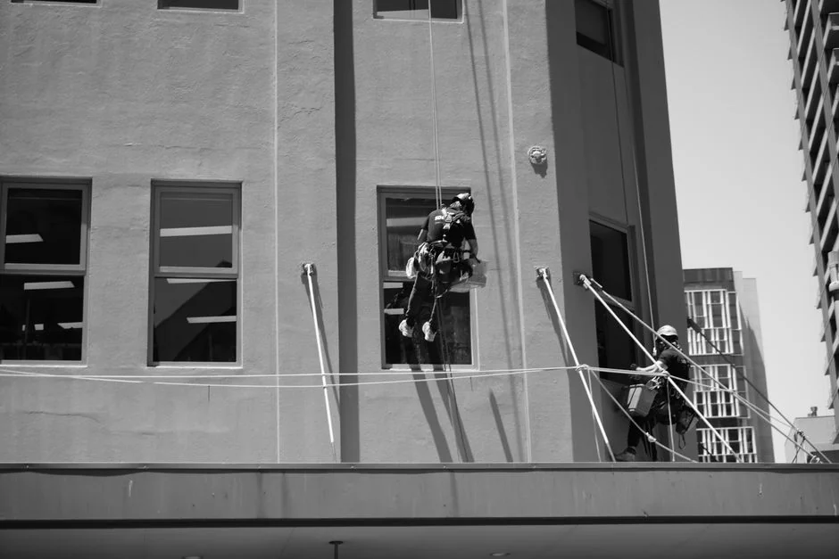Services-03 An individual disinfects a workspace using fumigation, wearing full protective gear for safety.